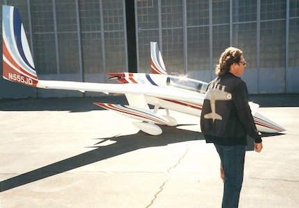 John Denver in front of his aircraft